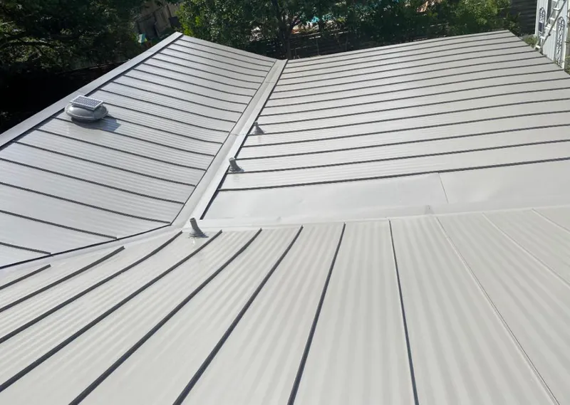 Solar attic fan installed on a metal roof for Roof Ventilation in South Park